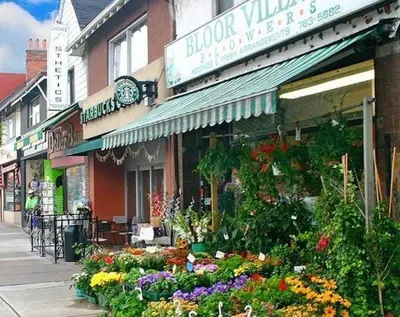 a flower shop with a bunch of flowers on a street at 1 Bedroom basement Suite in Junction Bloor West Village in Toronto
