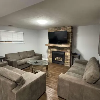 a living room with two couches and a fireplace at 5 Bedrooms, Mountain Views, Steps from Blue Mountain Village, Hot Tub, BBQ in Blue Mountains