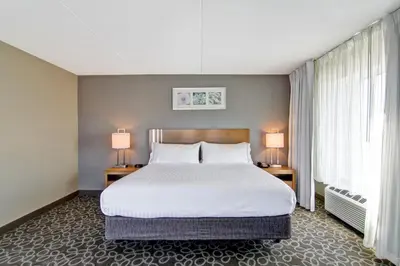 a bedroom with a large bed and two lamps at Holiday Inn Express & Suites Oshawa Downtown - Toronto Area by IHG in Oshawa