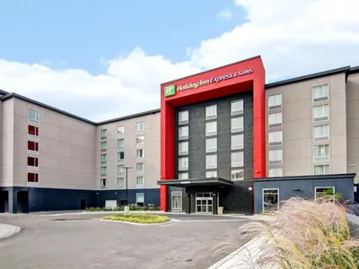a hotel with a red sign on the side of a building at Holiday Inn Express & Suites Oshawa Downtown - Toronto Area by IHG in Oshawa
