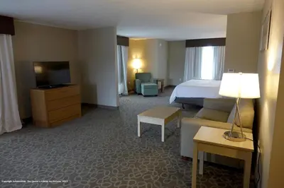 a hotel room with a bed and a television at Holiday Inn Express & Suites Oshawa Downtown - Toronto Area by IHG in Oshawa