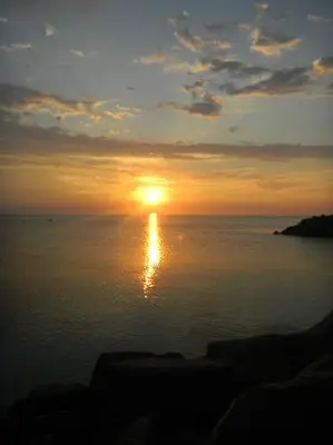 a sunset over the ocean with the sun in the sky at Royal Harbour Resort in Thornbury