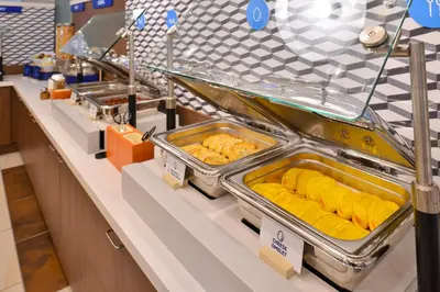a buffet line with trays of food on display at Holiday Inn Express & Suites Vaughan-Southwest by IHG in Vaughan
