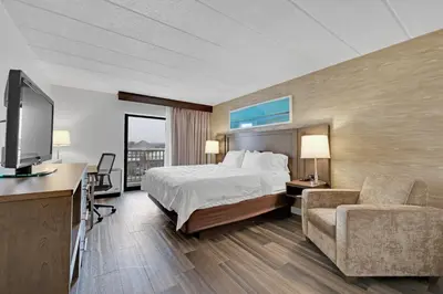 a hotel room with a bed and a tv at Holiday Inn Hotel Peterborough Waterfront by IHG in Peterborough