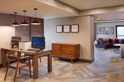 a living room with a desk with a computer on it at Four Points by Sheraton Hamilton - Stoney Creek in Hamilton