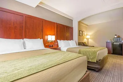 a hotel room with two beds and a kitchen at Comfort Inn & Suites in Collingwood