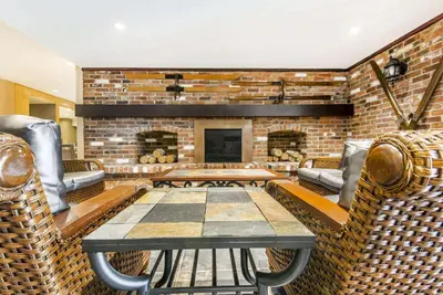 a large living room with a brick fireplace at Comfort Inn & Suites in Collingwood