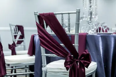 a table with a purple table cloth on a chair with a bow at Cambridge Hotel and Conference Centre in Cambridge