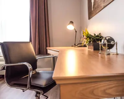 a chair sitting at a desk in a room at Cambridge Hotel and Conference Centre in Cambridge