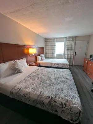 a hotel room with two beds and a window at 7 Nights Stay in Niagara Falls