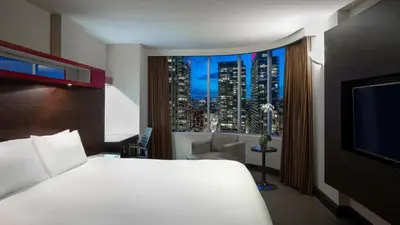 a hotel room with a bed and a large window at Hyatt Regency Toronto in Toronto