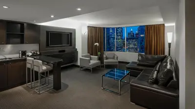 a living room with a couch and a table and a kitchen at Hyatt Regency Toronto in Toronto