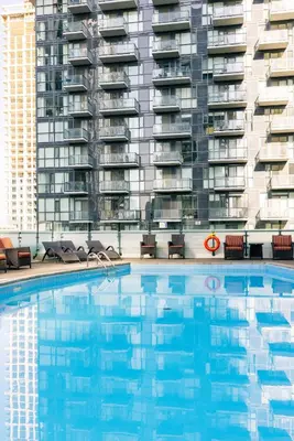 a swimming pool in front of a tall apartment building at Hyatt Regency Toronto in Toronto
