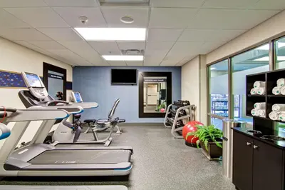 a gym with treadmills and machines in a room at Hampton Inn & Suites Guelph in Guelph