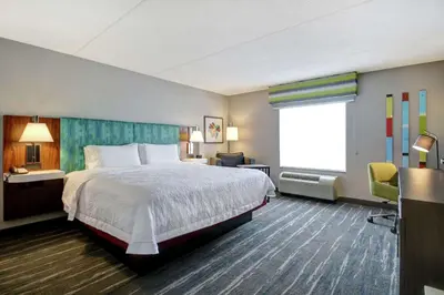 a hotel room with a bed and a window at Hampton Inn & Suites Guelph in Guelph