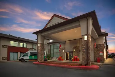 a building with a van parked in front of it at Quality Inn & Suites 5585 Ambler Drive Mississauga Ontario in Mississauga