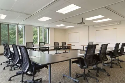 a conference room with tables and chairs in it at Spencer Hotel & Conference Centre in London