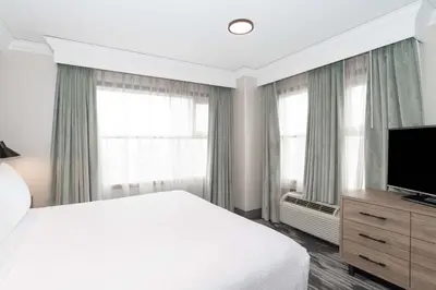 a bedroom with a bed and a flat screen tv at Sandman Signature Toronto Airport Hotel in Toronto