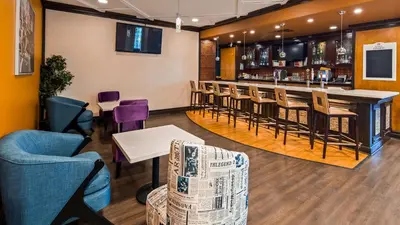 a bar in a restaurant with chairs and a counter at Best Western Premier Toronto Airport Carlingview Hotel in Toronto