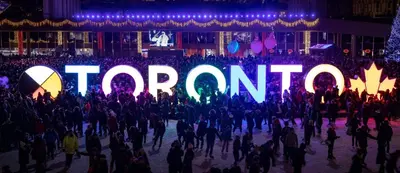 a crowd of people standing in front of a sign that reads tomorrow at Holiday Inn Toronto International Airport by IHG in Toronto