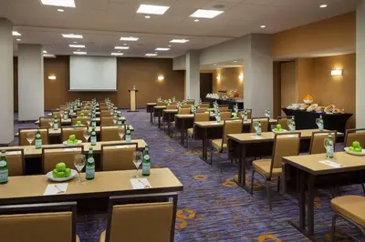a conference room with tables and chairs and a screen at TownePlace Suites by Marriott Toronto Northeast/Markham in Markham
