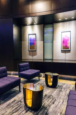 a waiting room with couches and tables and paintings at InterContinental Toronto Centre by IHG in Toronto