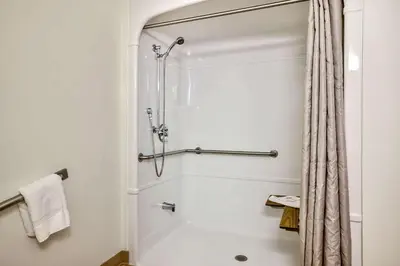 a bathroom with a shower with a shower curtain at Motel 6-Burlington, ON - Toronto West - Oakville in Burlington