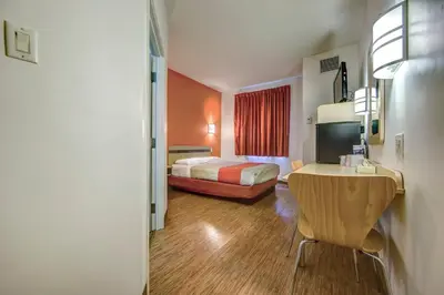 a hotel room with a bed and a desk in it at Motel 6-Burlington, ON - Toronto West - Oakville in Burlington