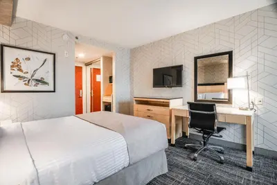 a hotel room with a bed and a desk at Monte Carlo Inn Barrie - Newly Renovated in Barrie