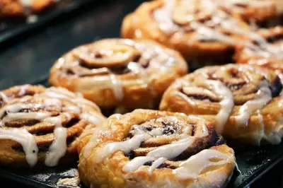 a bunch of donuts with icing on a tray at Holiday Inn Express Hotel & Suites Toronto - Markham by IHG in Richmond Hill
