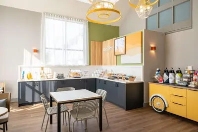 a kitchen and dining room with a table and chairs at Spark By Hilton Toronto Markham in Markham