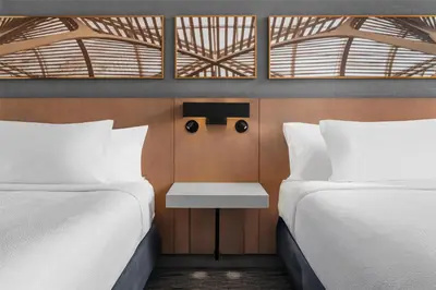 a bedroom with two beds and a table between them at Hilton Garden Inn Toronto Airport in Mississauga