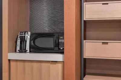 a microwave sitting on a shelf in a kitchen at Hilton Garden Inn Toronto Airport in Mississauga