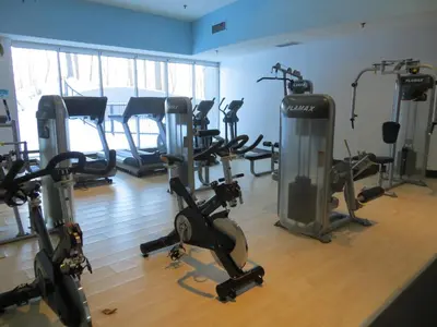 a gym with several exercise bikes in a room at Toronto Don Valley Hotel and Suites in Toronto