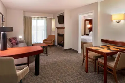 a hotel room with a desk and a living room at Residence Inn by Marriott Gravenhurst Muskoka Wharf in Gravenhurst