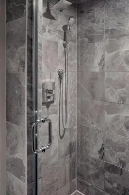 a shower with a glass door in a bathroom at Niagara Falls Marriott Fallsview Hotel & Spa in Niagara Falls
