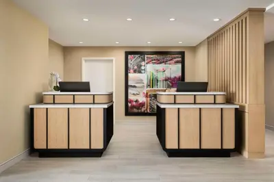 a lobby with two reception desks with laptops on them at Sonesta ES Suites Toronto Markham in Markham