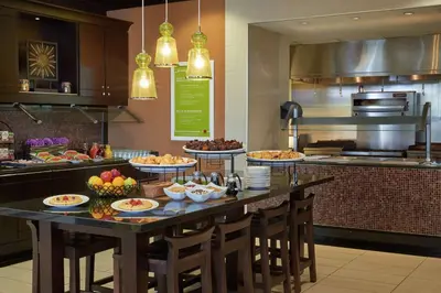 a kitchen with a table with food on it at Hilton Garden Inn Toronto Airport West/Mississauga in Mississauga