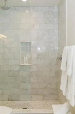 a bathroom with a shower with a glass door at Woodbourne Inn in Niagara on the Lake
