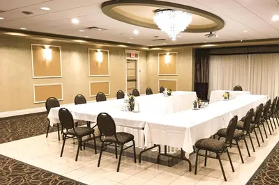 a large meeting room with a long table and chairs at Rodeway Inn Festival in Stratford