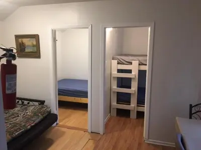 a bedroom with two bunk beds and a mirror at Wasaga Bridge Cottages in Wasaga Beach