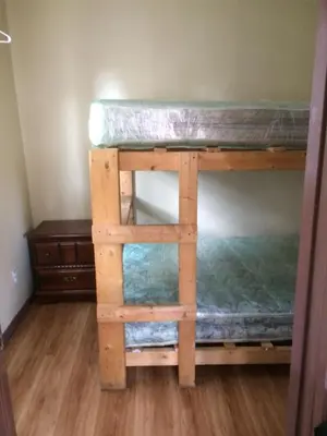 a bunk bed in a room with a wooden floor at Wasaga Bridge Cottages in Wasaga Beach