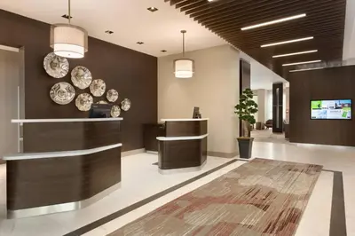 a lobby with plates on the wall and a counter at Courtyard by Marriott Toronto Mississauga/West in Mississauga
