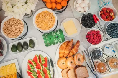 a table filled with different types of food on plates at Newton Villa in Brampton