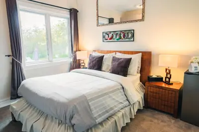 a bedroom with a large bed and a window at Newton Villa in Brampton