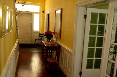 a hallway with a table and chairs in a room at The Chepstow Inn in Chepstow