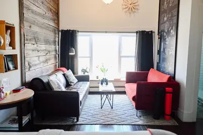 a living room with a couch and two chairs at Edison's Inn in Stratford