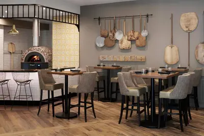 a restaurant with tables and chairs and a fireplace at Delta Hotels by Marriott Guelph Conference Centre in Guelph