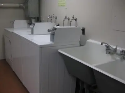 a bathroom with two sinks and two toilets at University of Toronto - New College Residence - Wilson Hall Residence in Toronto