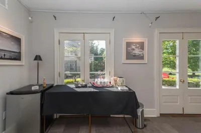 a white room with a table with a black table cloth at The Old Bank House in Niagara on the Lake